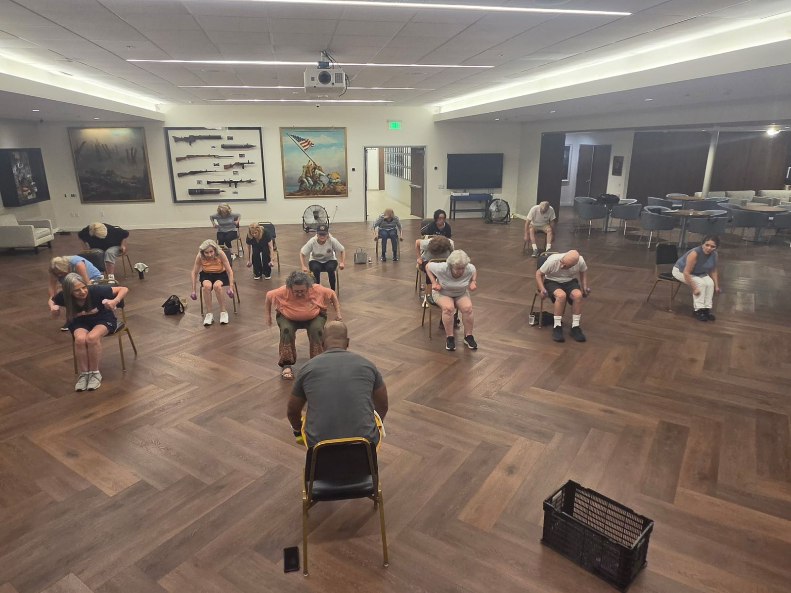 Coach Todd guiding a senior class through a seated strength exercise